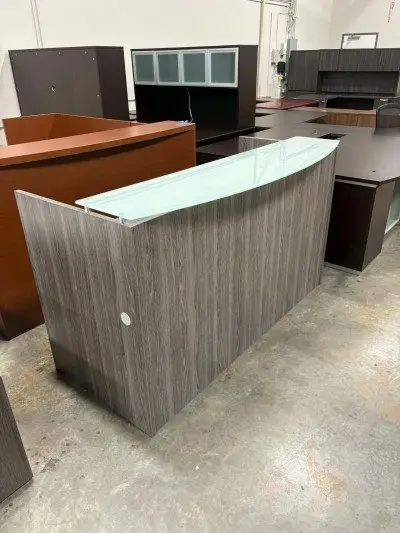 Pre owned grey reception desk with glass top at Peach State Office Furniture, Atlanta