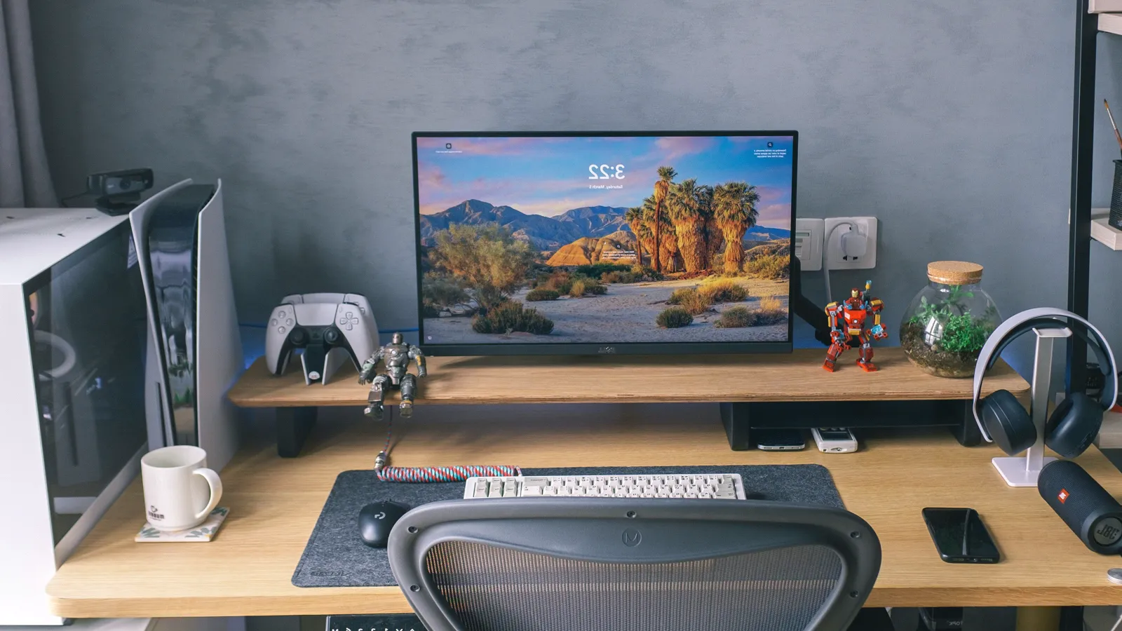 Home desk setup with a Herman Miller Aeron chair, monitor and game console